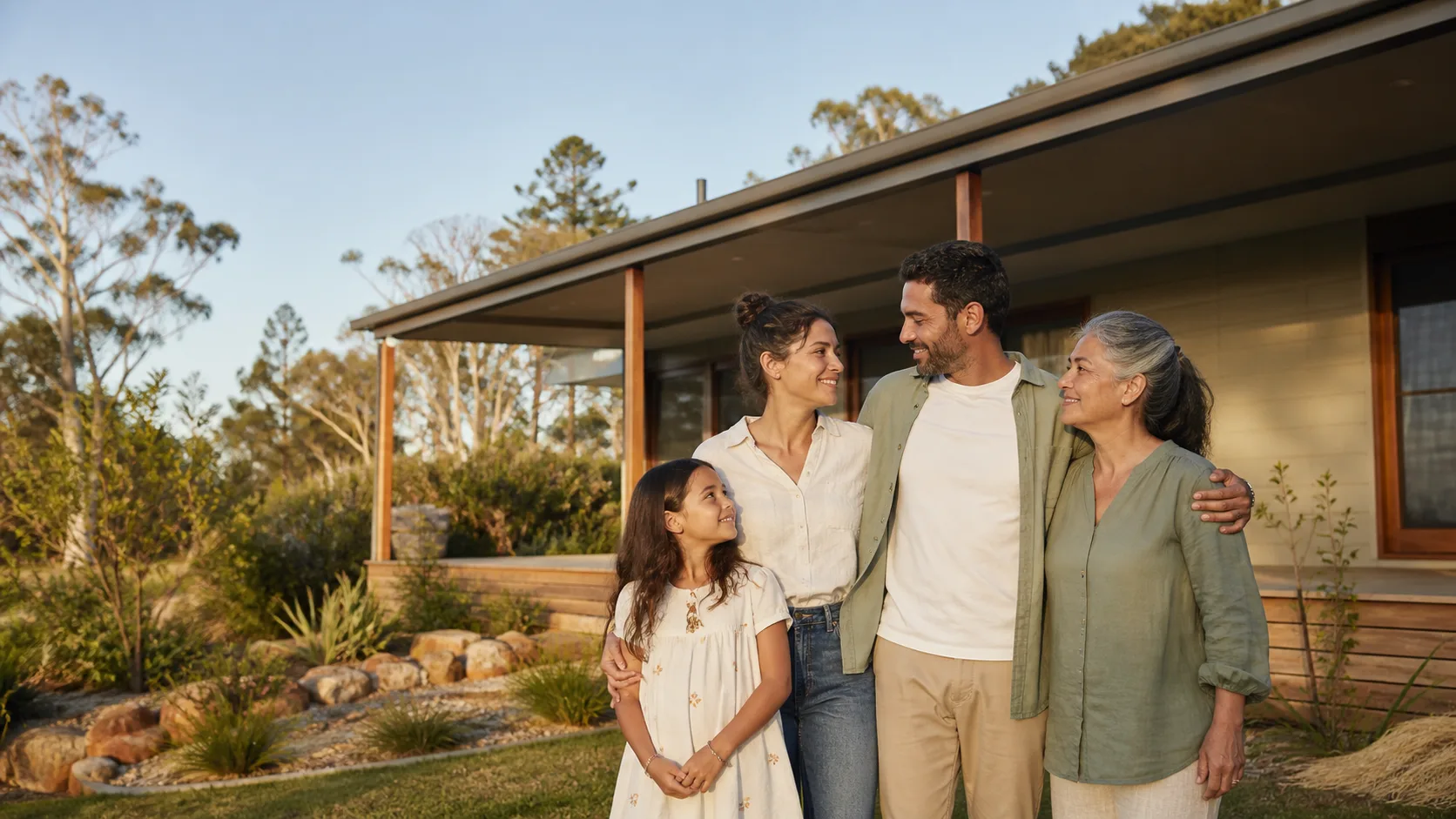 An Australian family looking ahead together outside their home
